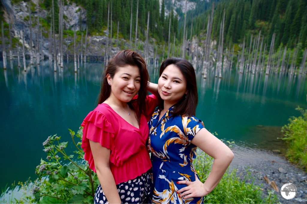 Two Kazakh girls striking a pose on the shores of Lake Kaindy.