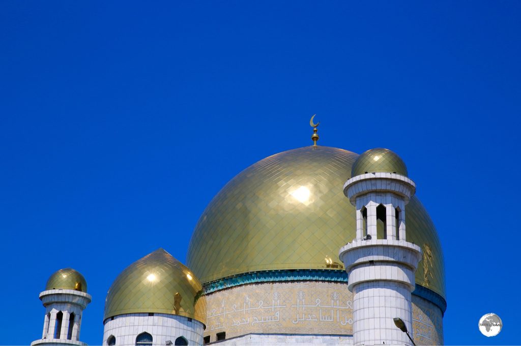 The large gold dome of the Almaty Central Mosque is decorated with verses from the Quran.