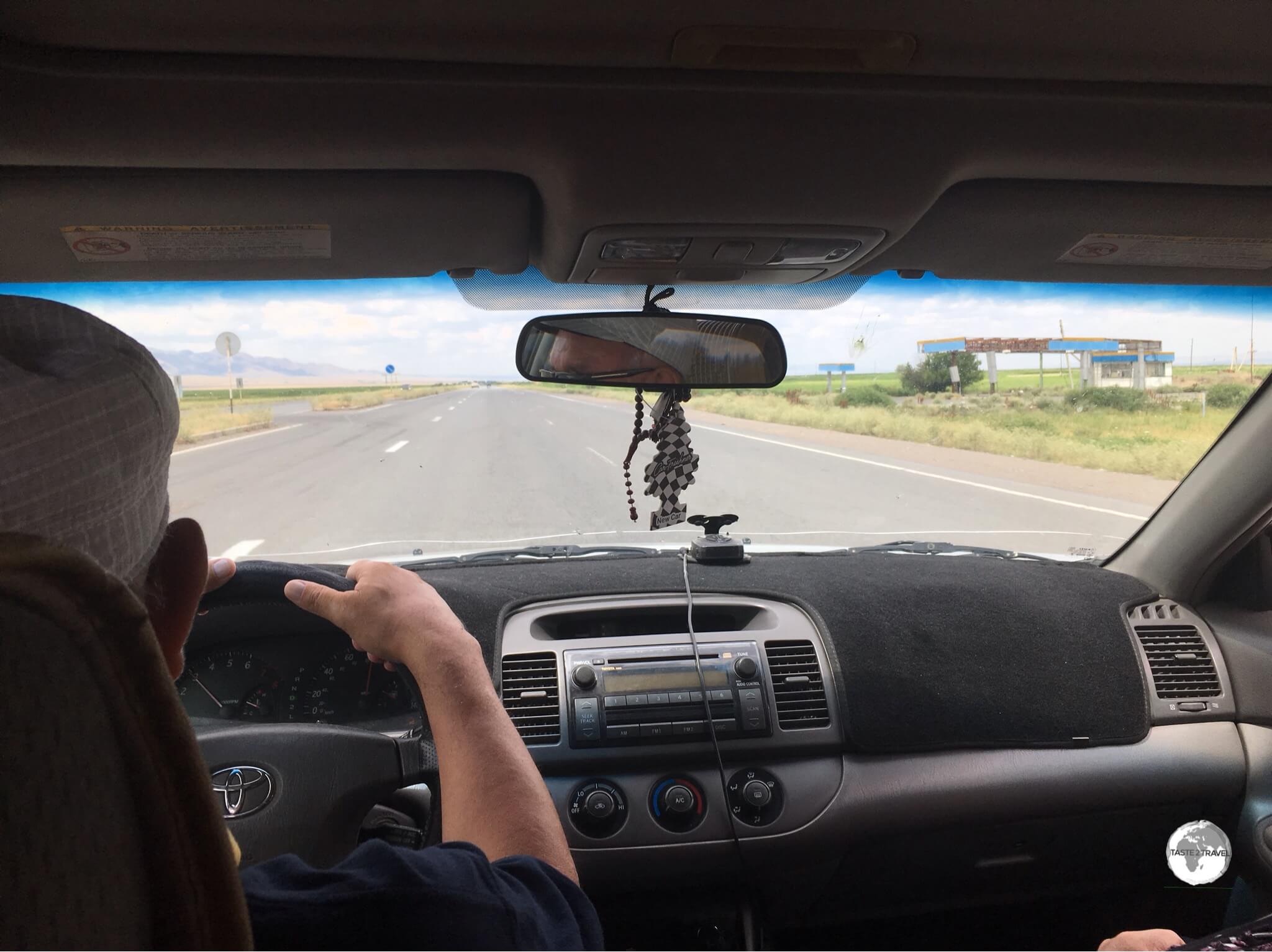 On the road in a shared taxi from Almaty to Bishkek.