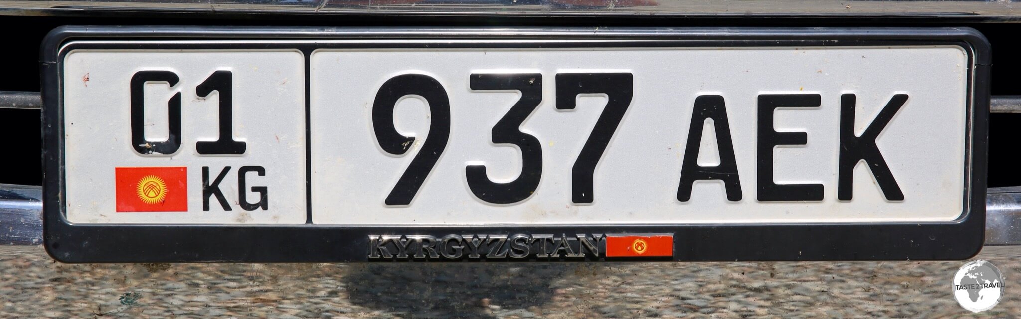 The Kyrgyzstan license plate on my rental car.