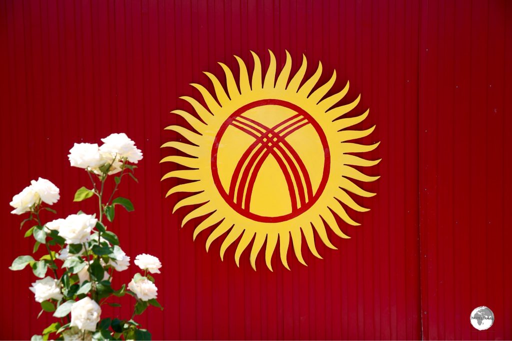 This Kyrgyzstan flag adorns the wall of a colourful house in the town of Karakol.