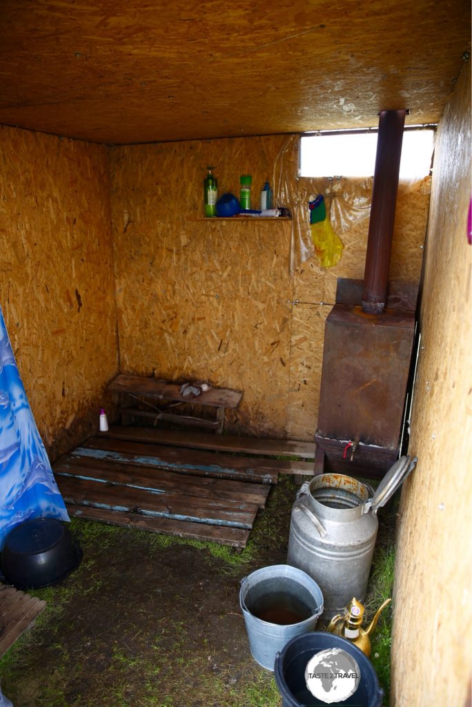 The shower at the yurt camp, where ice-cold mountain water is heated using a manure-fired stove.