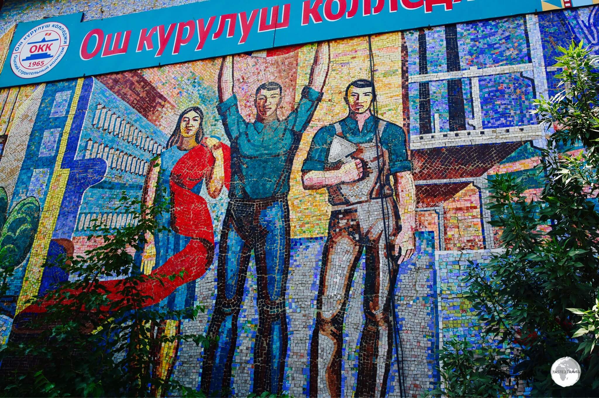 The <b><i>Fabric</i></b> mosaic is installed on the wall of a local technical college and shows three different workers, with one holding a length of red cloth, a symbol of communism.