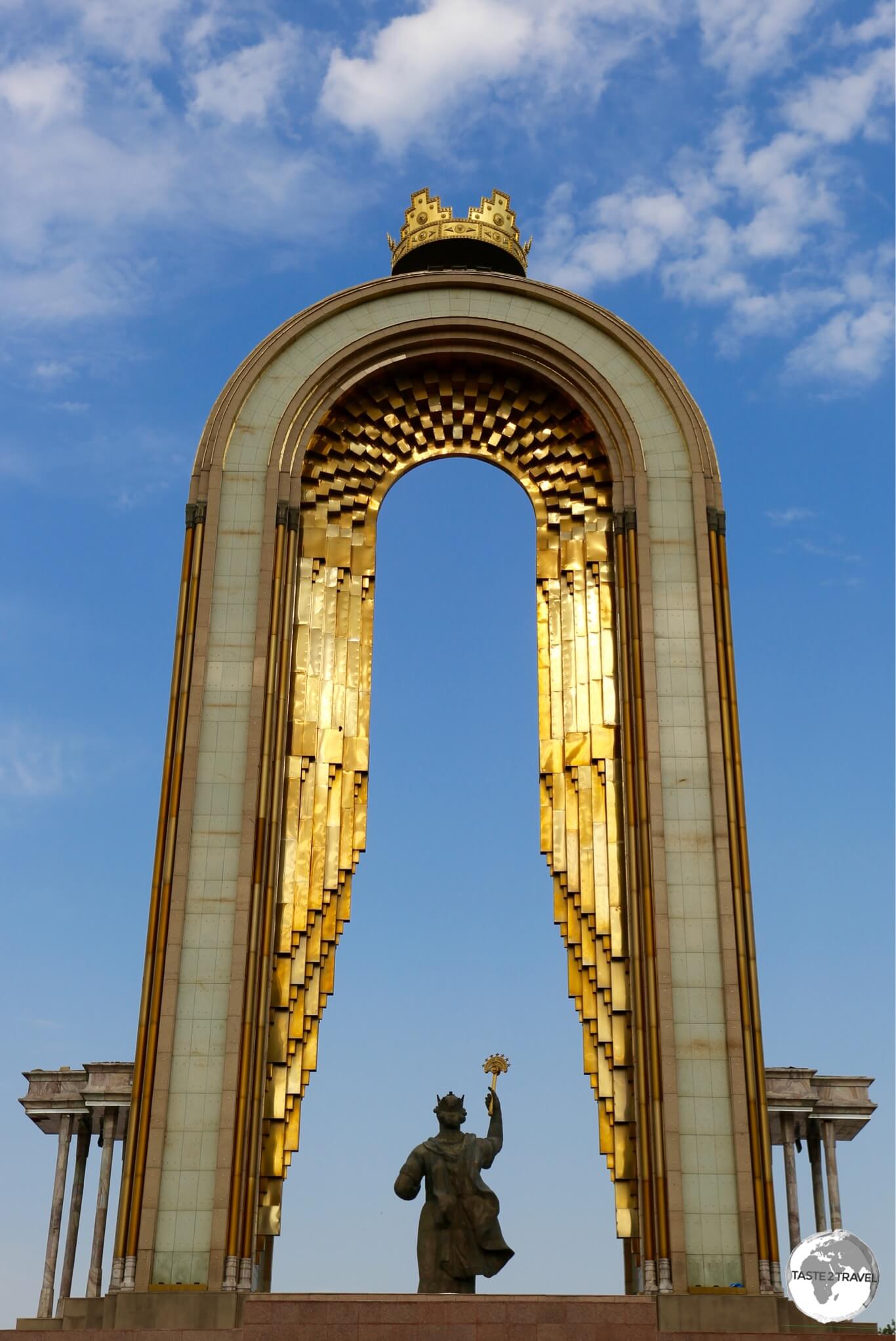 The Ismoili Somoni Statue illuminated at sunset.