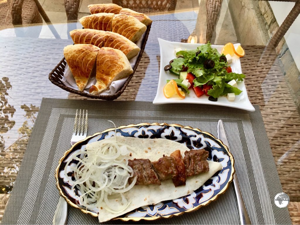A delicious dinner at Restaurant ”Old Bukhara” – shashlik, Greek salad and fresh Bukhara bread.