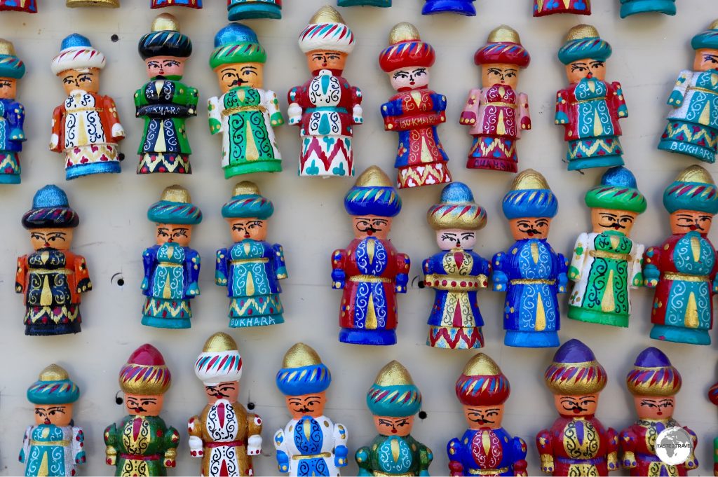 Hand-carved, wooden, souvenir fridge magnets for sale in Bukhara.