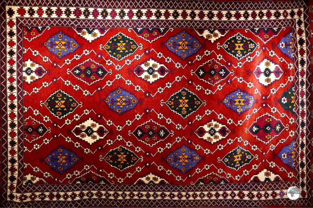 Uzbek carpets are characterised by a field of red-brown tint, which is populated by brightly coloured medallions, which usually appear in geometrical shapes.