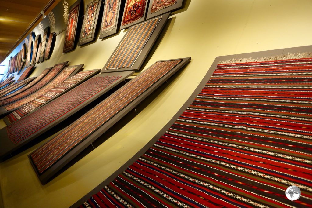 How to display a flat carpet on a curved wall? Carpets on display at the Carpet Museum.