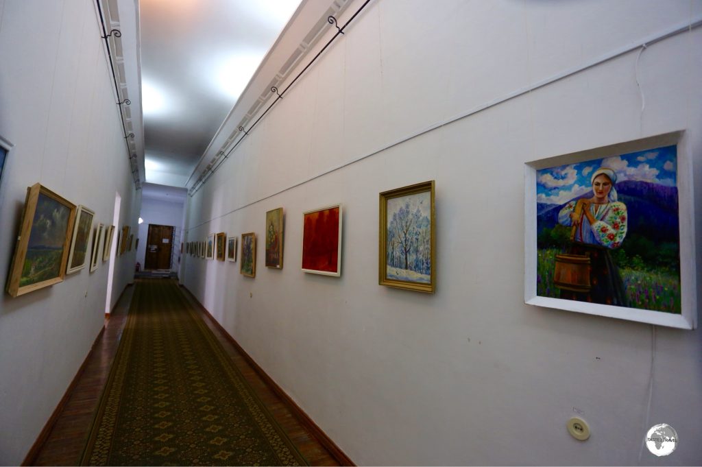 A hallway at the museum is lined with paintings from local artists.