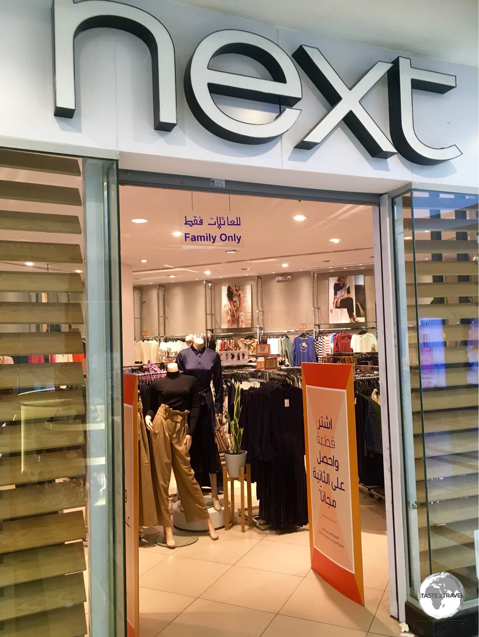 A sign inside a branch of the 'Next' clothing store in Jeddah indicates that only 'Families' are allowed in the store.