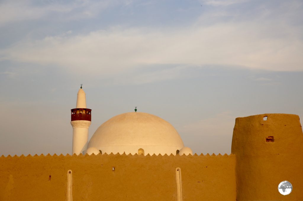The dome of the Al-Qubba mosque rises above the mud walls of the Ibrahim Palace compound.