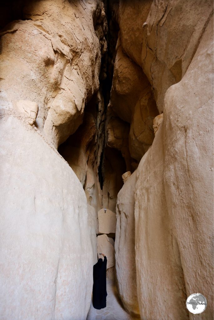 A visitor inside one of the cavities of Al Qarah Mountain.