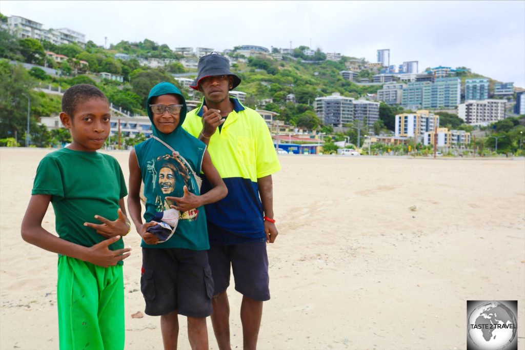 Young boys enjoying a walk along Ela beach.