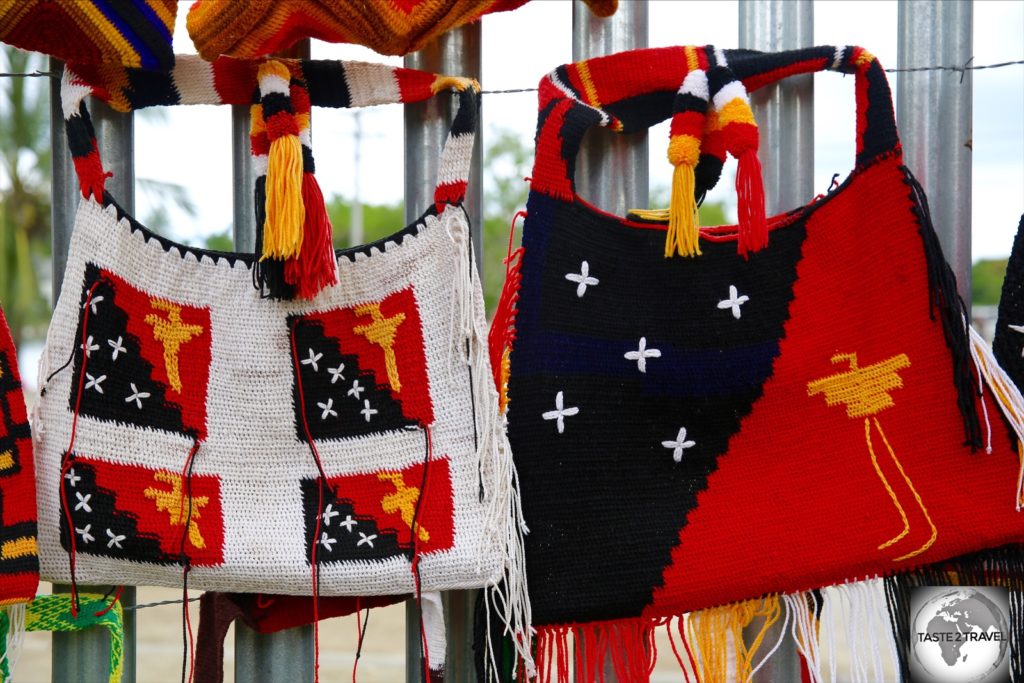 The flag of PNG is often featured in souvenirs such as these Bilums (bags) in Madang market.