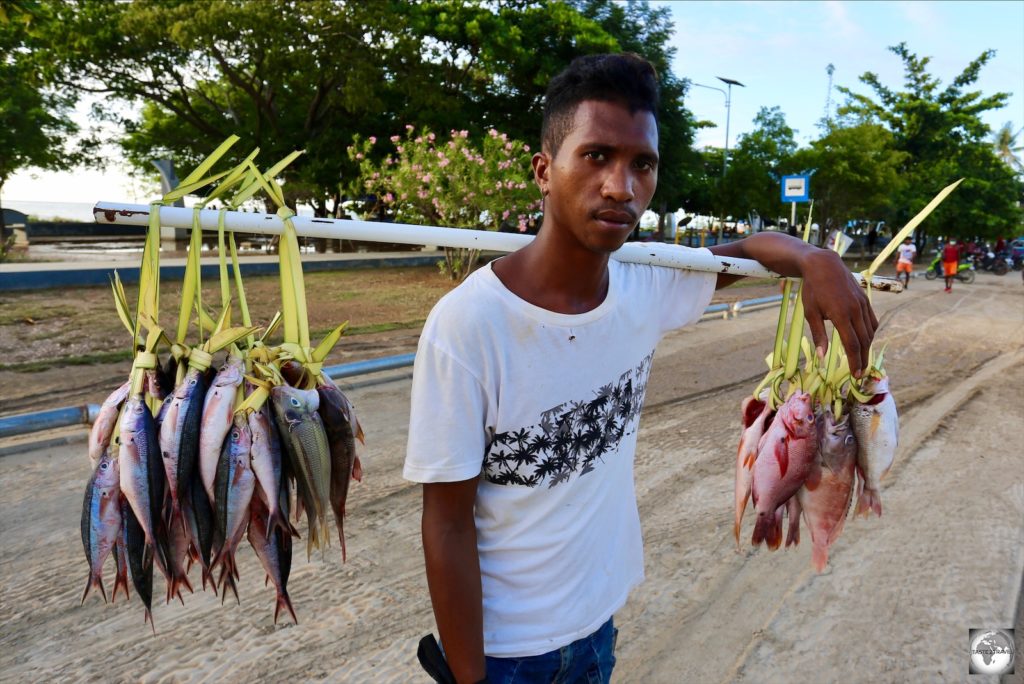 A fish vendor, on the waterfront in Dili.