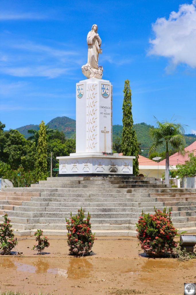 The Monument to Our Lady in Fatima Park is surrounded by a slurry of mud which washed down from the mountains during a flash flood the day before. The mud covered the entire city.