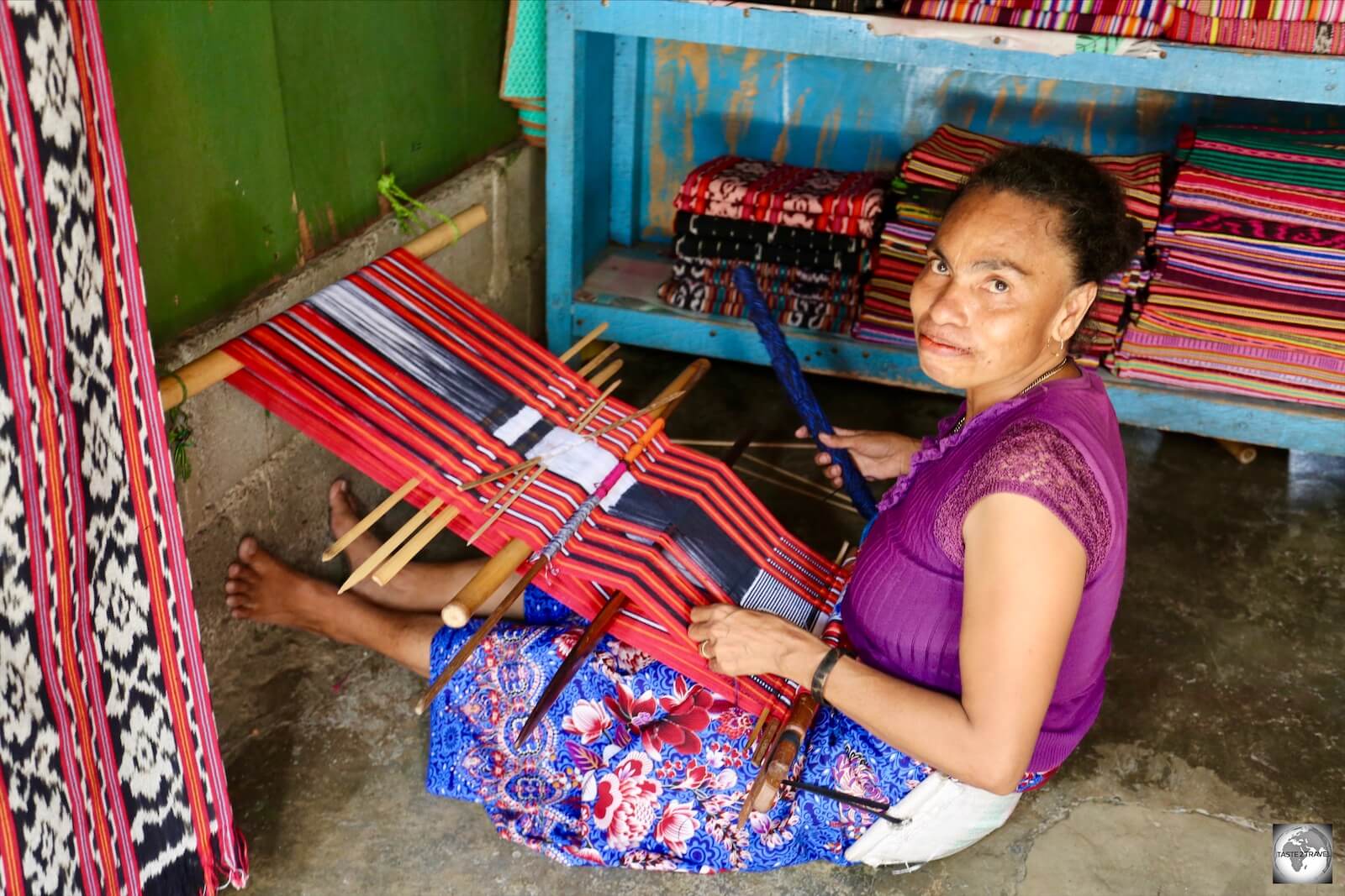 A store owner weaving Tais cloth at the Tais market in Dili.