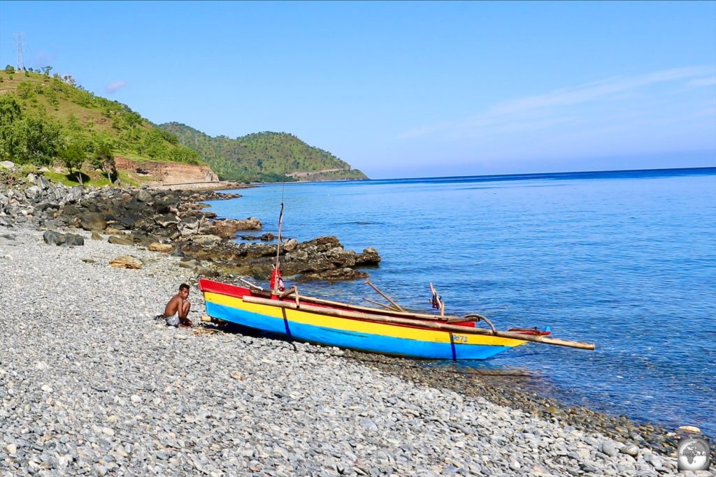 A colourful, traditional, wooden fishing boat on a beach east of Dili.
