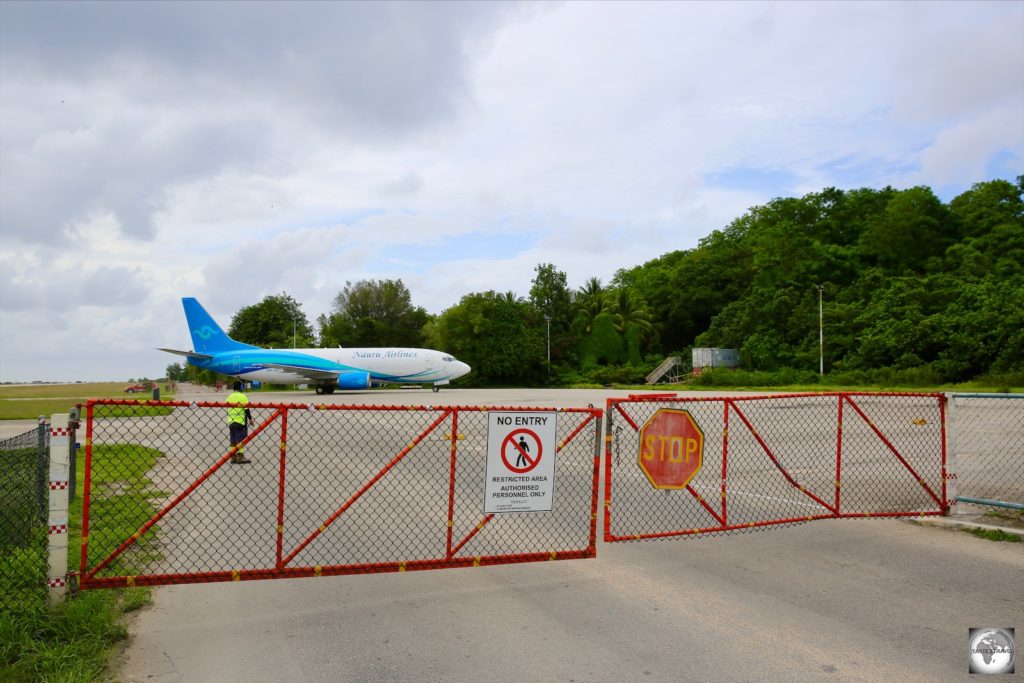 When planes are present at Nauru airport, this portion of the Island Ring road, which doubles as the taxiway and apron at the airport, is closed to traffic.
