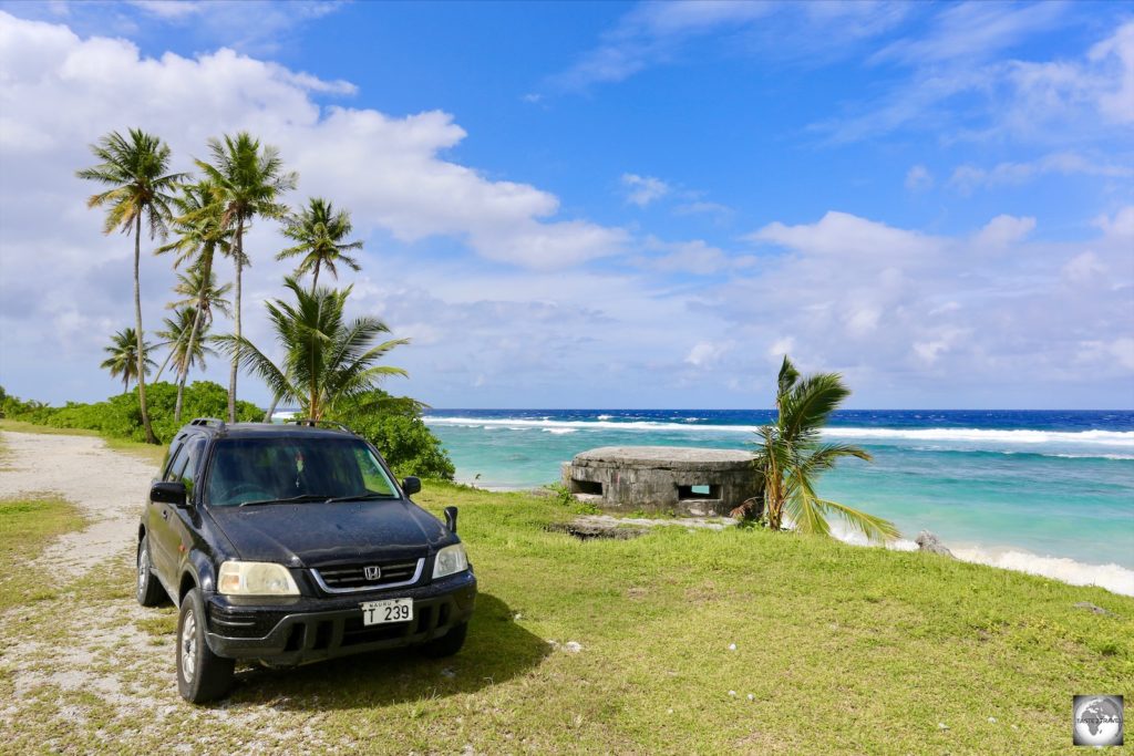 My rental car alongside one of the Japanese WWII pillboxes (concrete dug-in guard post), which can be seen along the coast of Nauru.