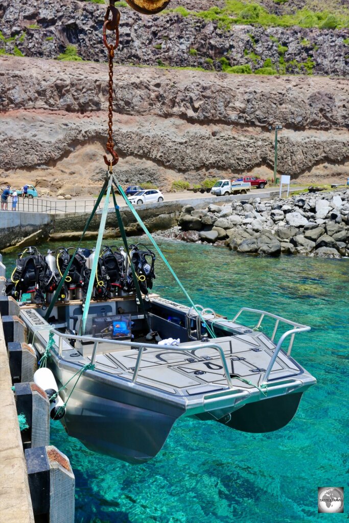 Lowering our dive boat into the sea at Cascade pier.