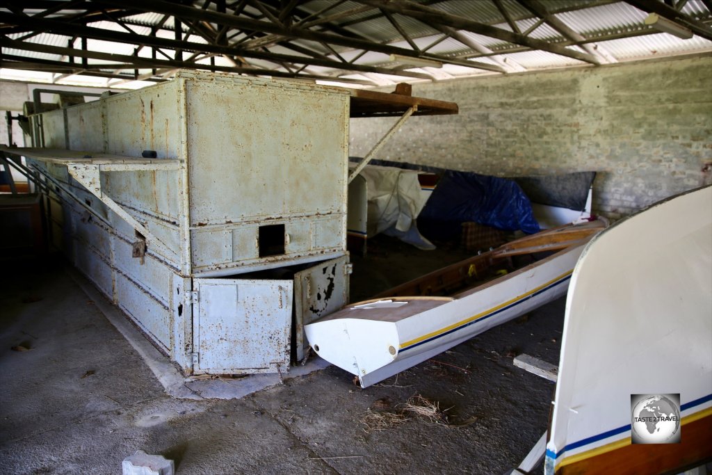An abandoned oven, which was once used for drying coconuts, and renovated Jukong boats at the Home Island museum.