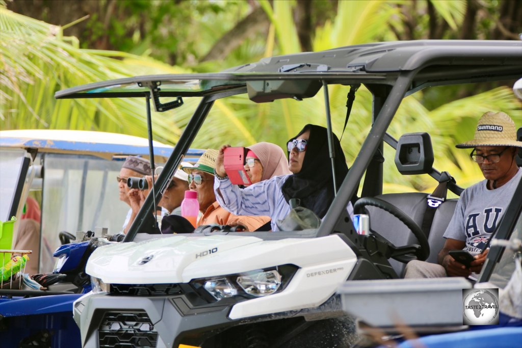 Cocos Malay locals on Home Island watching the monthly Jukong boat race from the comfort of their buggies.