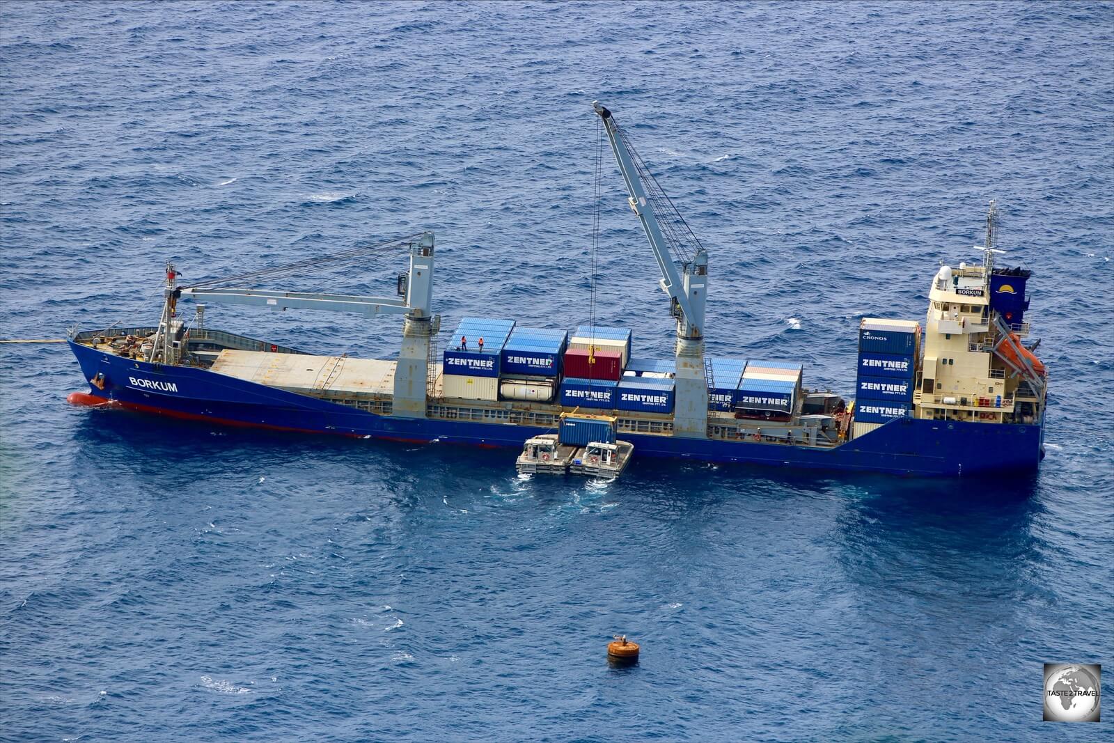 A container ship being unloaded at sea at Christmas Island port.