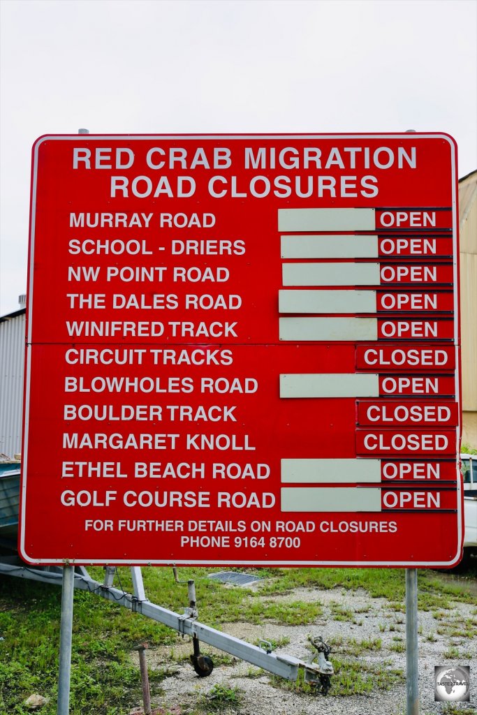A road sign in Settlement indicates road closures during the Red Crab migration season.