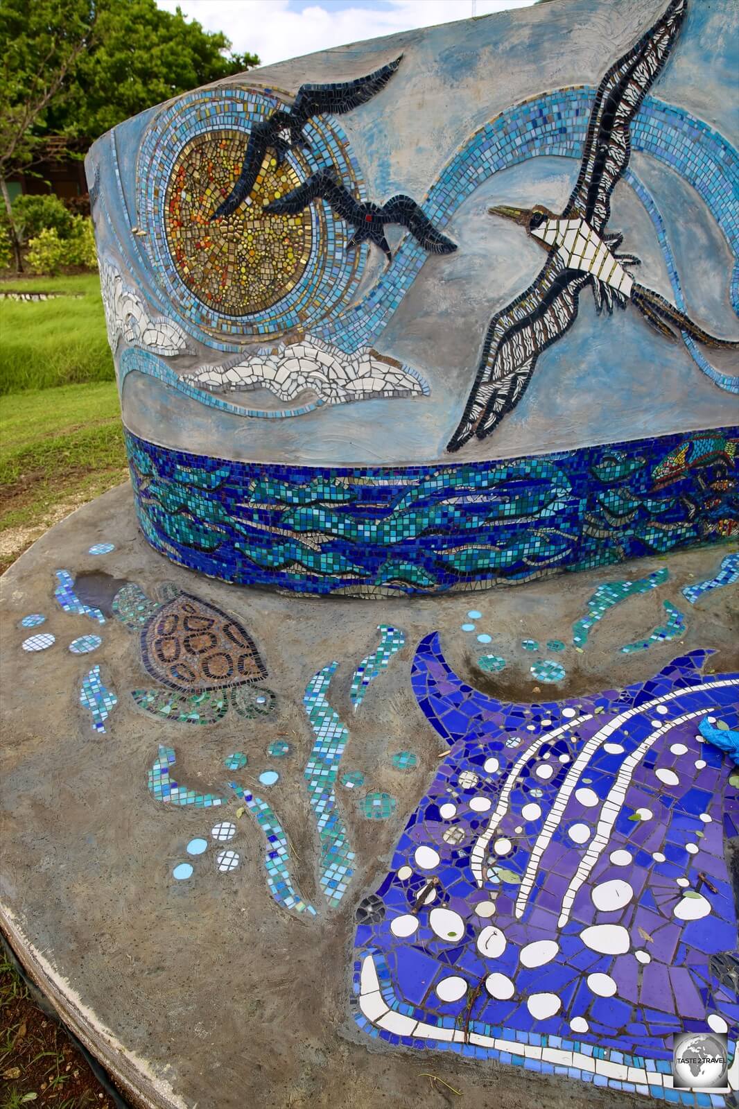 A whale shark, frigatebirds, a booby and more feature on a newly installed, community-made, tile mosaic in the park in Settlement.