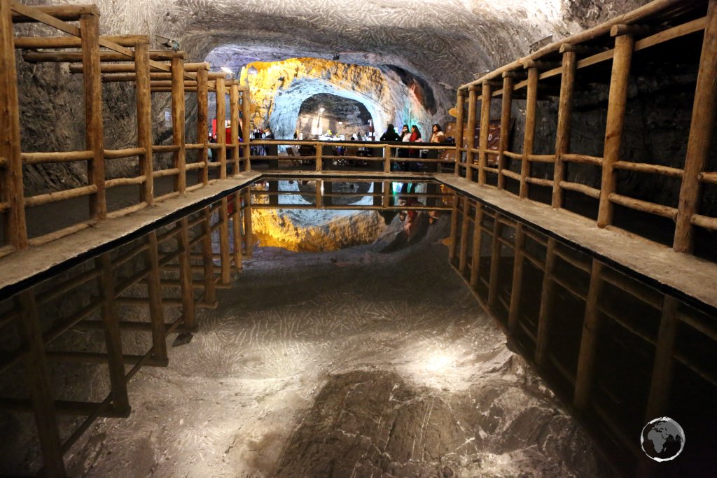 A pool of water at the Salt Cathedral of Zipaquirá forms a mirror, perfectly reflecting the ceiling above.
