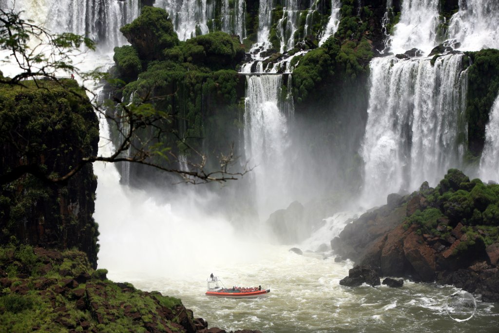 Passengers in a Brazilian tour boat, feeling the spray at the base of Iguazú Falls.
