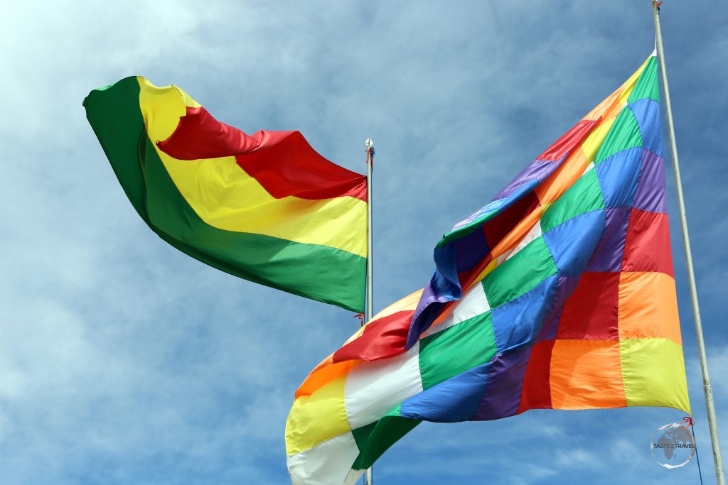 The official Bolivian flag and the multi-coloured 'Wiphala of Qulla Suyu', the official variant flag of Bolivia and a symbol for the indigenous people of the Andes.