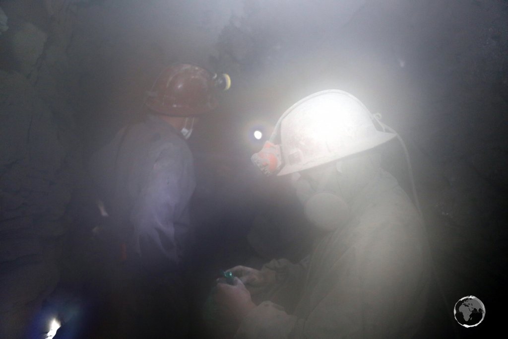 Dust settles after a dynamite explosion. Due to poor worker conditions and a lack of OH&S practices, many of the miners contract silicosis and have a life expectancy of around 40 years.