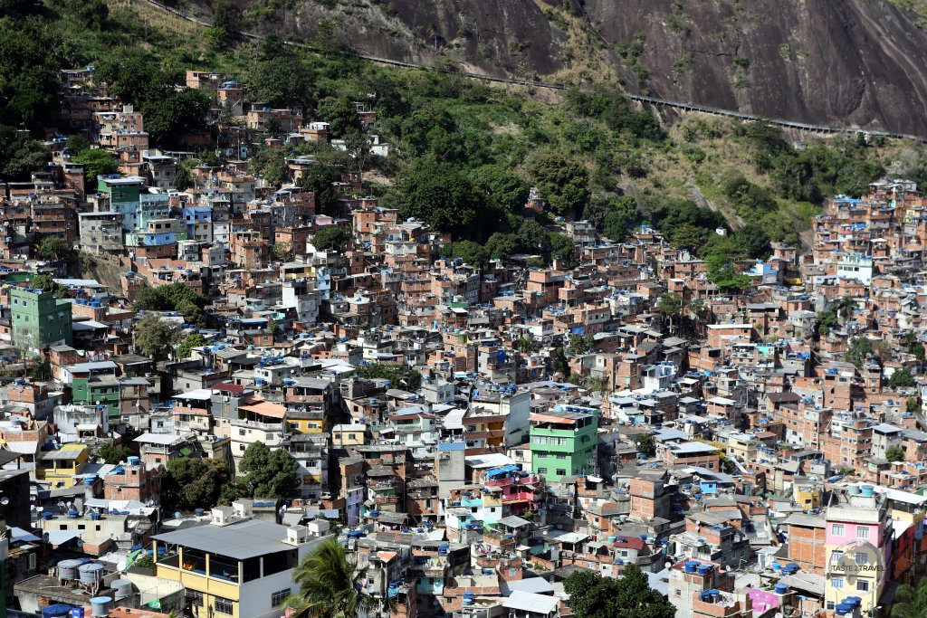 Rocinha favela is built on a steep hillside overlooking Rio de Janeiro. Around 100,000 people live in this colourful neighbourhood.