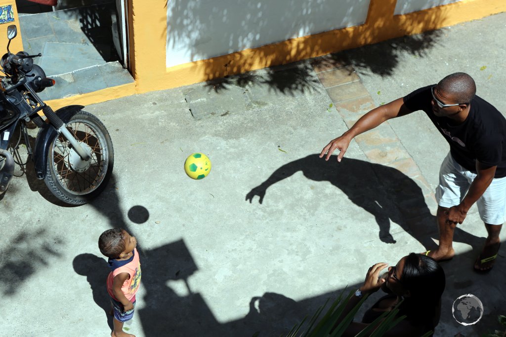 Father and child playing football in Olinda, Pernambuco state, Brazil.