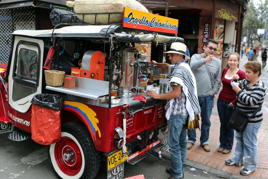 A coffee vendor, selling freshly brewed Colombian coffee from the back of his 'Willys' jeep in downtown Bogota.