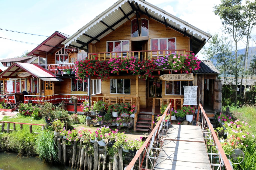 Swiss-style houses line the streets of a small tourist village at Laguna La Cocha. The speciality of the local restaurants is trout which is caught in the lake.