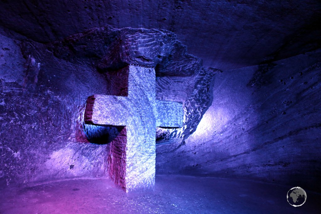 A large cross, hewn out of rock salt, lies in the depths of the Zipaquirá Salt Cathedral in Colombia.