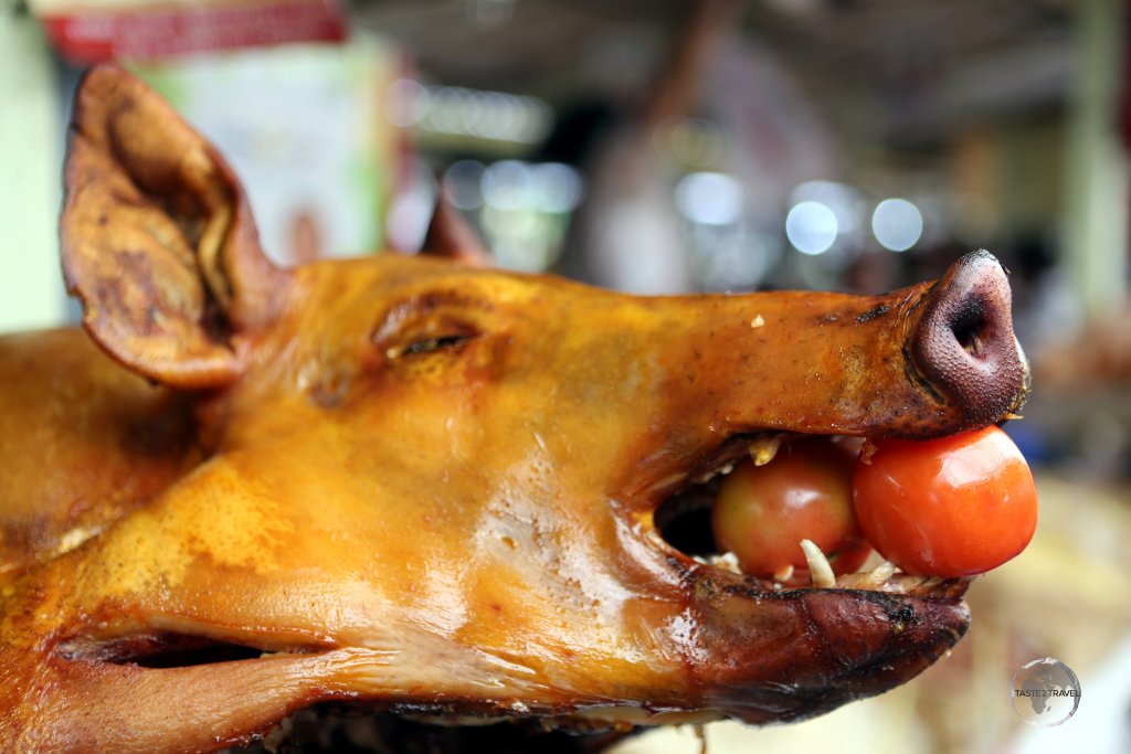 Food, including freshly roasted pig, is abundant at Otavalo market.