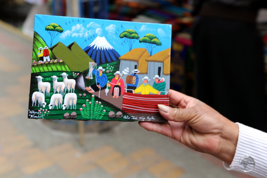 Colourful artworks, depicting typical Andean scenes, are popular souvenirs at the weekly craft market in Otavalo, Ecuador.