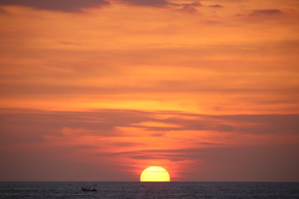 Sunset over the Pacific Ocean at the beachside town of Olón, Ecuador.