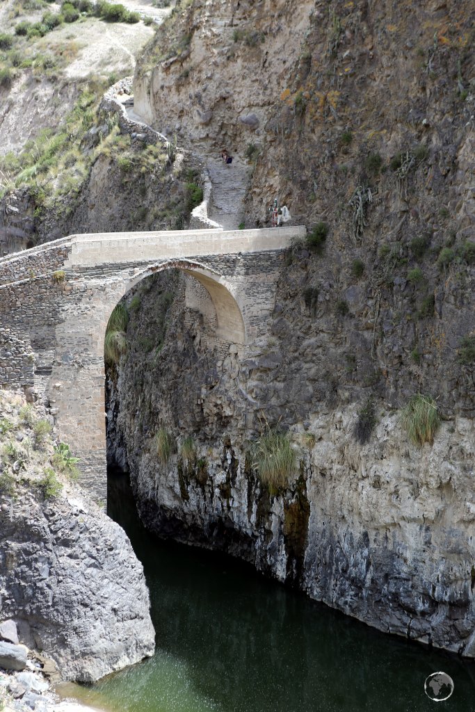 An engineering marvel, an Inca-built stone bridge crosses the Colca river, near the the Chacapi hot springs, near the town of Yanque, Peru.