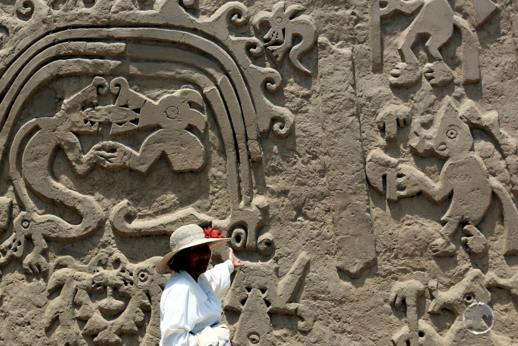 Sonia, my Trujillo guide, explaining the adobe friezes, which includes a rainbow, at Huaca Arco Iris (Rainbow Temple), a Chimú period pyramid, Trujillo, Peru
