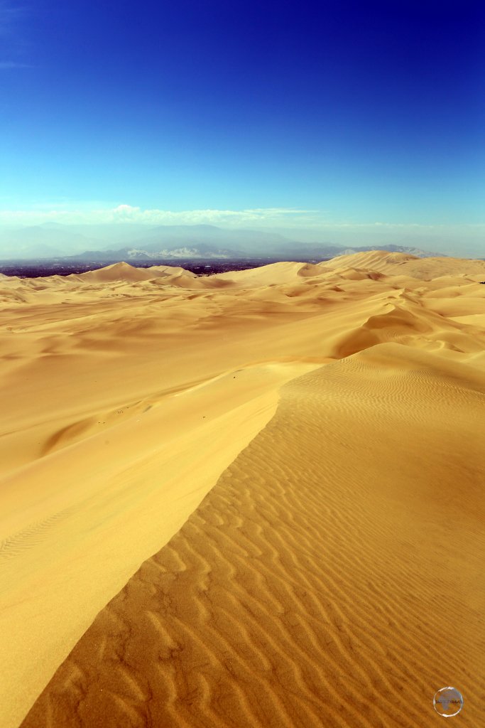 Sand dunes around the Peruvian oasis town of Huacachina, with the foothills of the Andes visible in the background.