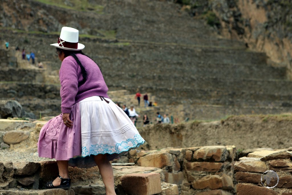 A Peruvian tourist, exploring Ollantaytambo ruins. Built in the 1400s, the large Inca fortress soars above the cobbled streets of Ollantaytambo town, 95 km north of Cuzco.