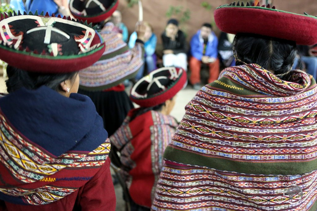 Quechua weavers at the 'Chinchero Centre for Traditional Culture', wearing their woven garments, which they sell to visiting tourists.