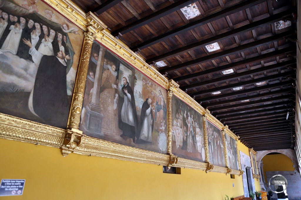 Religious artworks adorn the walls of a colonnade, at the Convent of Santo Domingo, which the Spanish built over the top of the Inca-built Coricancha in Cusco, Peru.
