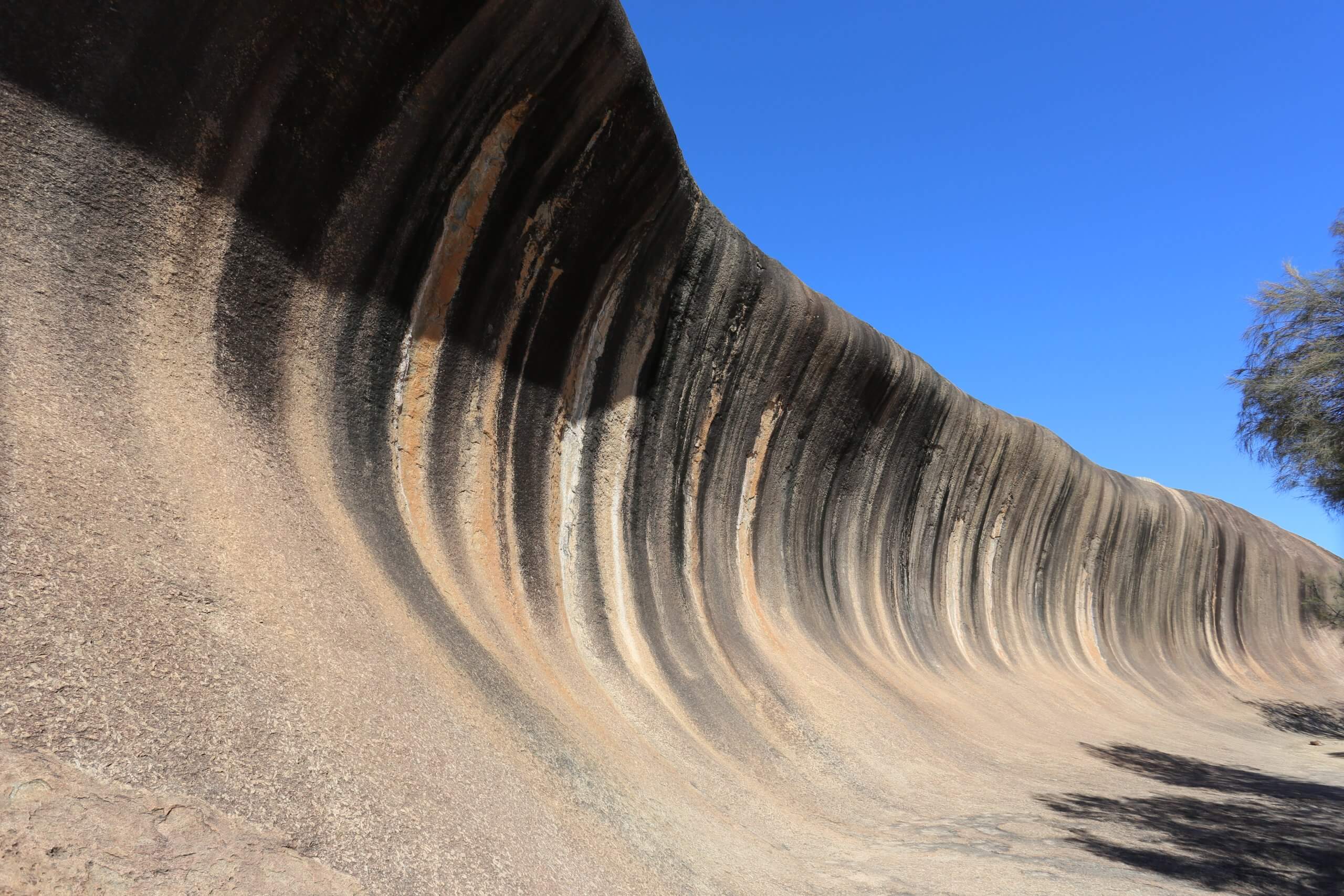 Located in Hyden, Wave Rock is a natural, inland, rock formation that is shaped like a tall breaking ocean wave.
