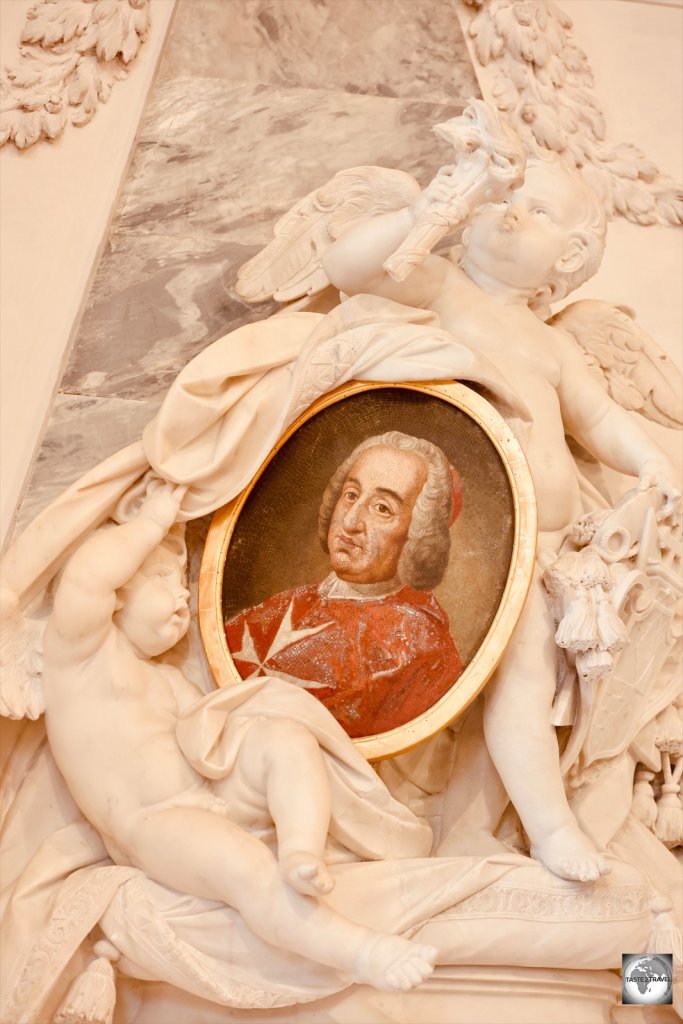 Stucco relief surrounds an Order of Malta Grand Master, inside Santa Maria del Priorato church.